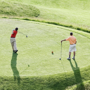 Two friends playing golf at a golf course