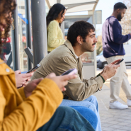 People waiting for the bus at a transit station